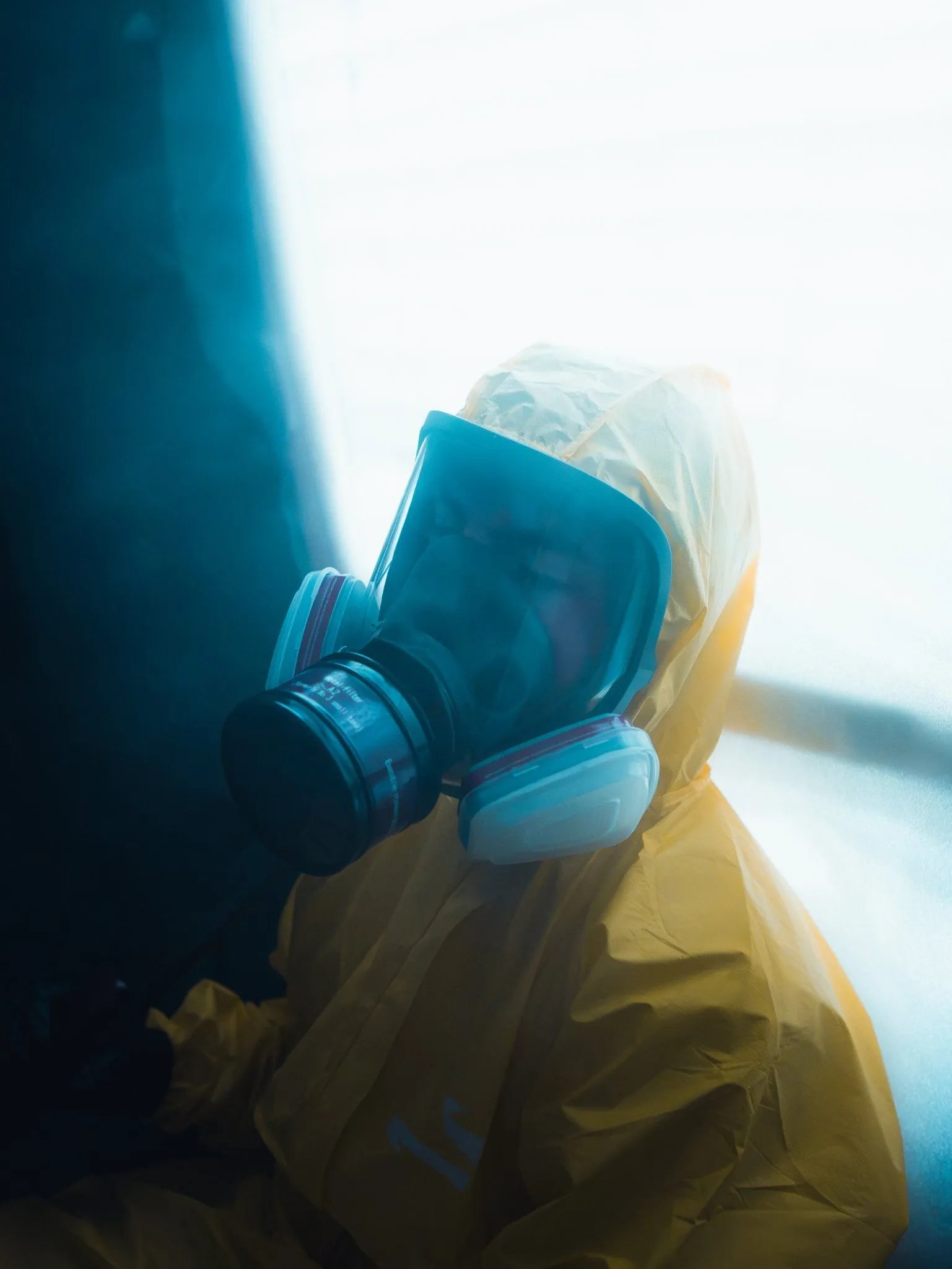 Person in protective gear lit by blue and yellow campaign light